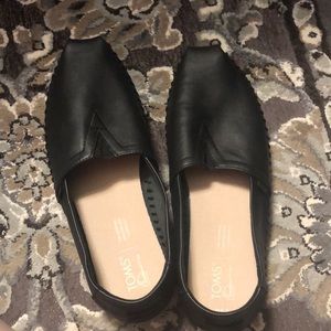 Black leather TOMS.